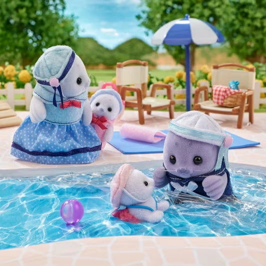 Sylvanian Families Seal Family beside a swimming pool, with the mother and one baby standing poolside while the purple seal father plays in the water with the other baby.