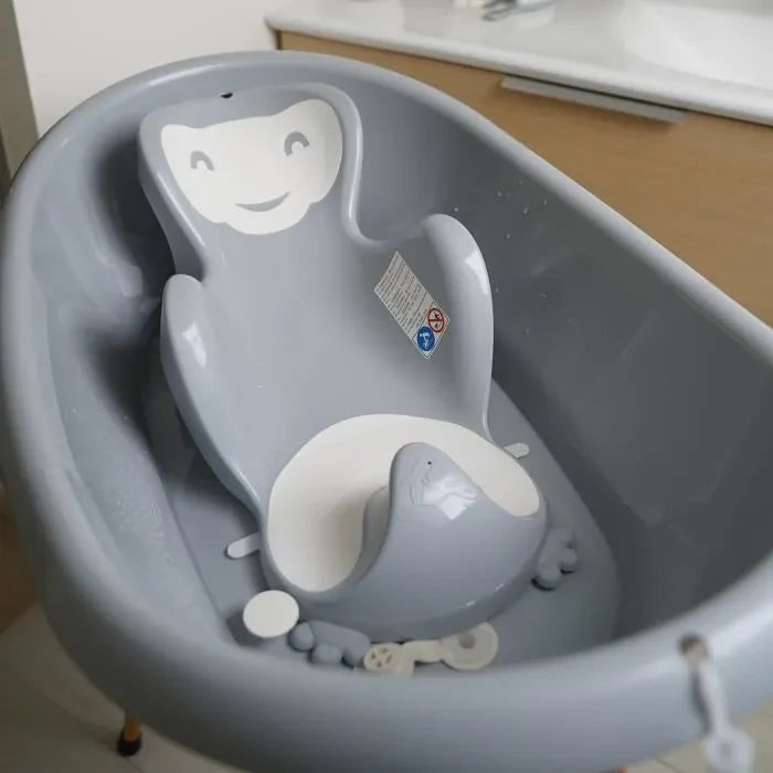 Thermobaby Babycoon Grey Charm Bath Seat shown inside a grey baby bath