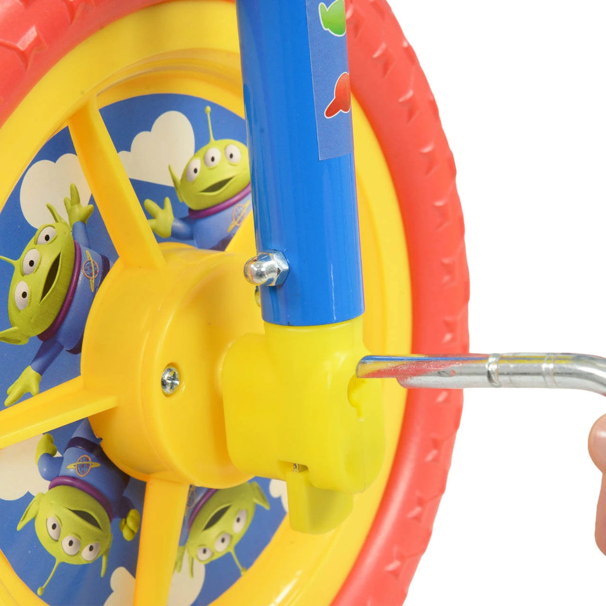 Close up of the yellow pedal area and wheel with Toy Story alien graphics