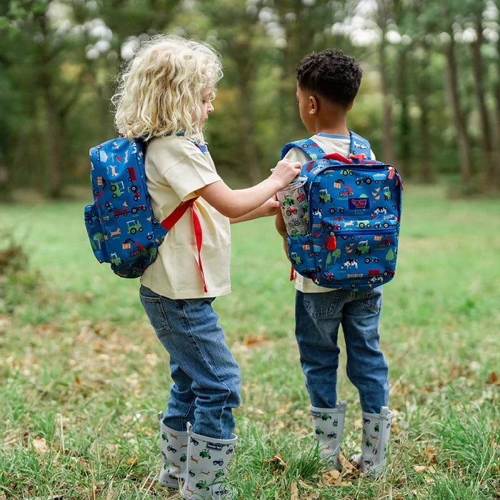Tractor Ted Farmyard Rucksack in an outdoor setting with green countryside surroundings.