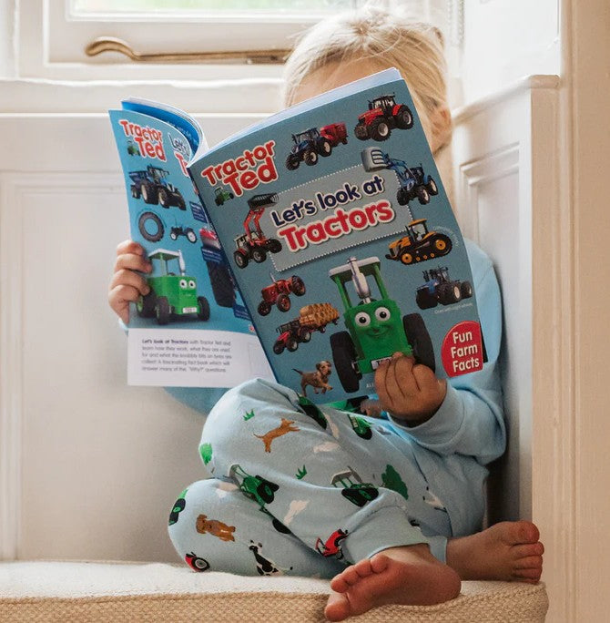 Child reading Tractor Ted Let's Look at Tractors book in Ireland