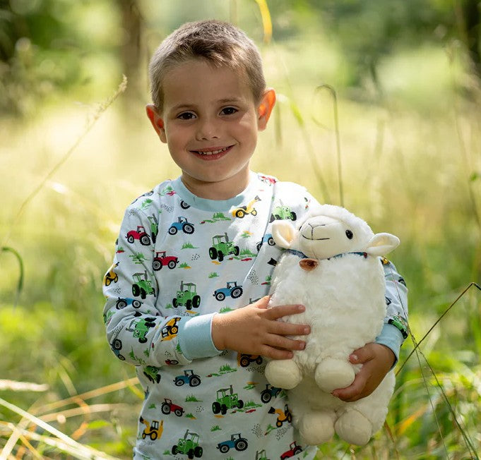 Child hugging Meadow the Sheep Soft Toy by Tractor Ted Ireland