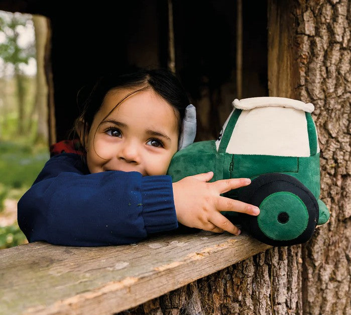 Child cuddling Tractor Ted Soft Toy outdoors Ireland