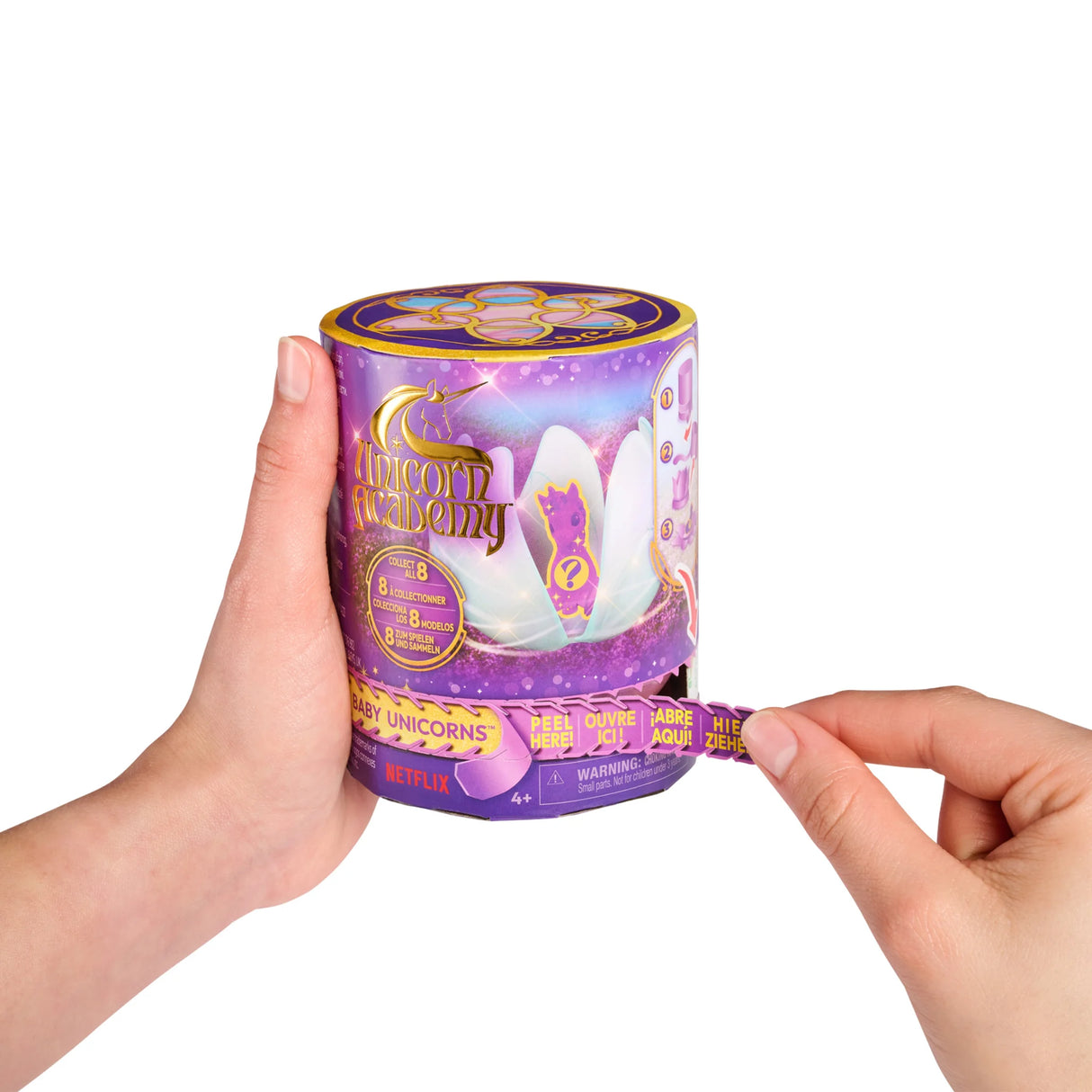 Hand peeling open Unicorn Academy baby unicorn packaging – Ireland