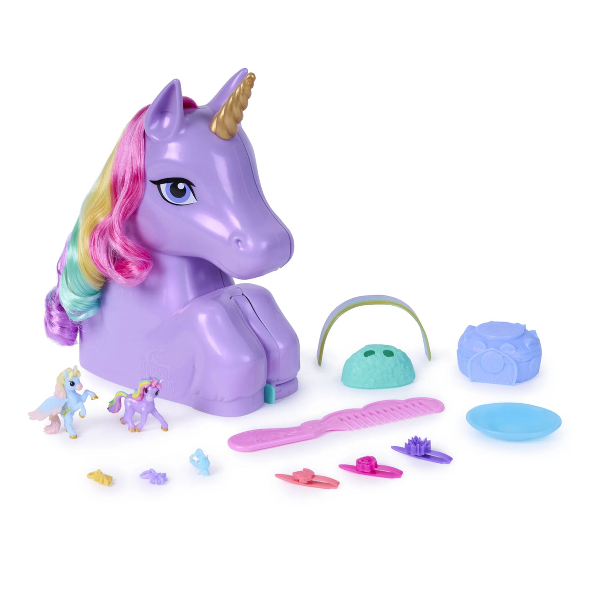 Purple Wildstar styling head with rainbow mane beside two unicorn figures, comb, clips and other accessories