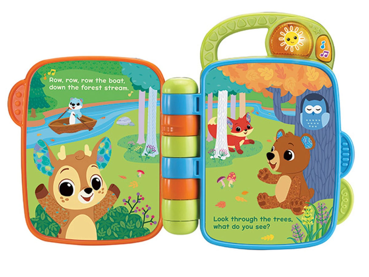 VTech Animal Rhymes Storytime open book showing farm scene with dog, sheep, cow and cat illustrations and printed rhyme text