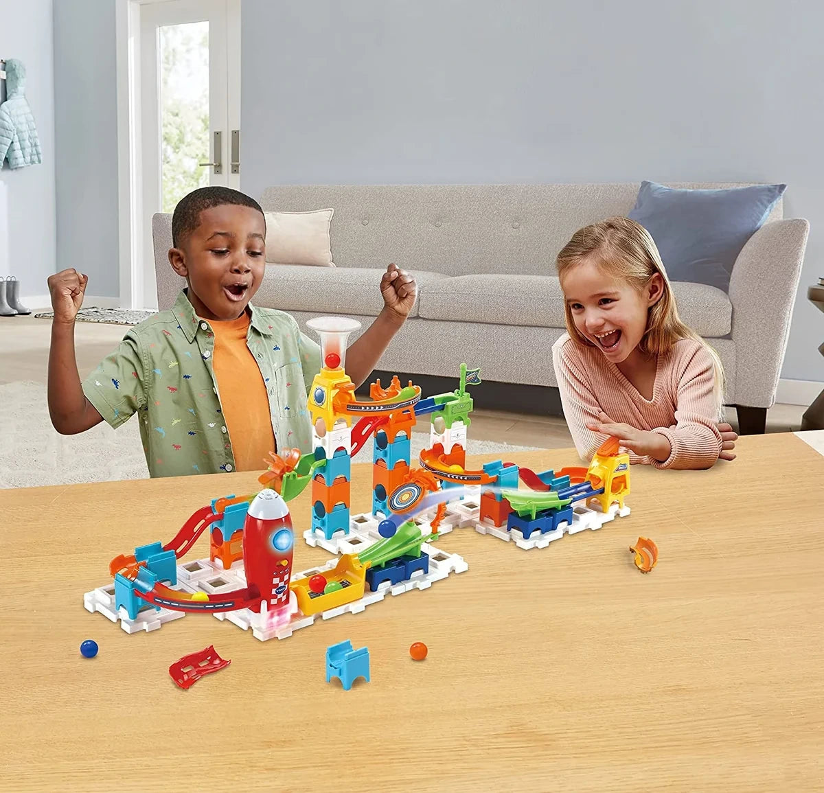 Children playing with the VTech Marble Rush Launch Pad built with ramps, towers, launchers and coloured marbles