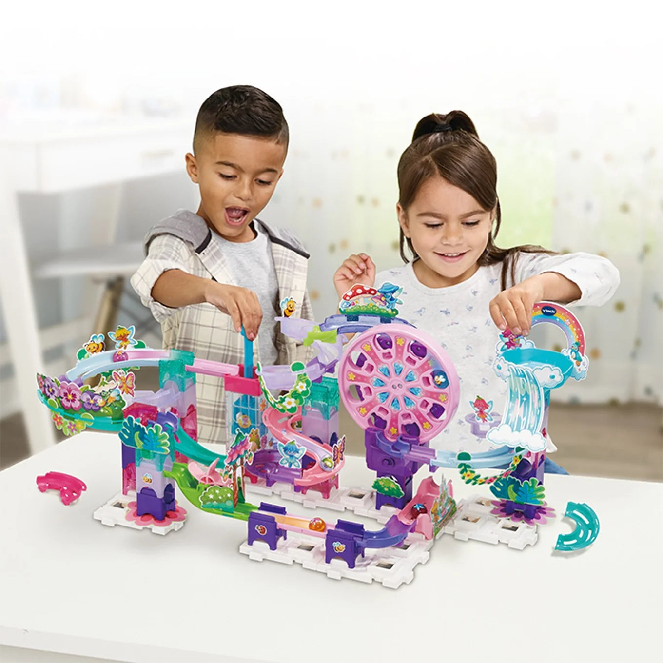 Two children playing with the VTech Marble Rush Petal Power marble run on a tabletop at home – Ireland.