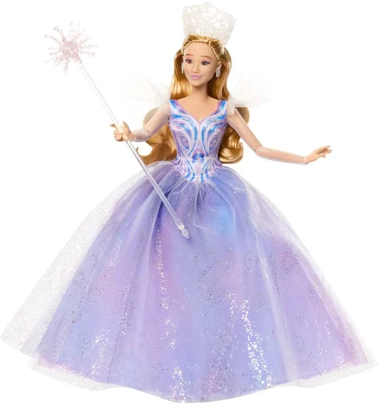 Glinda doll posed holding wand and wearing tiara, styled in multi-layer gown with flutter sleeves and curled blonde hair