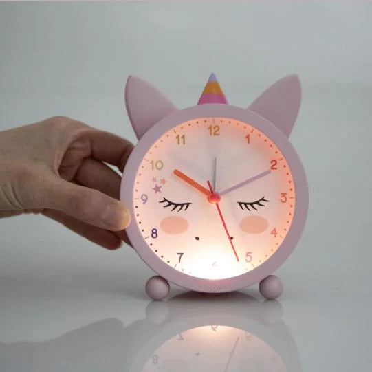 Ylvi Unicorn Alarm Clock illuminated with built in night light glowing in pink unicorn design in Ireland.