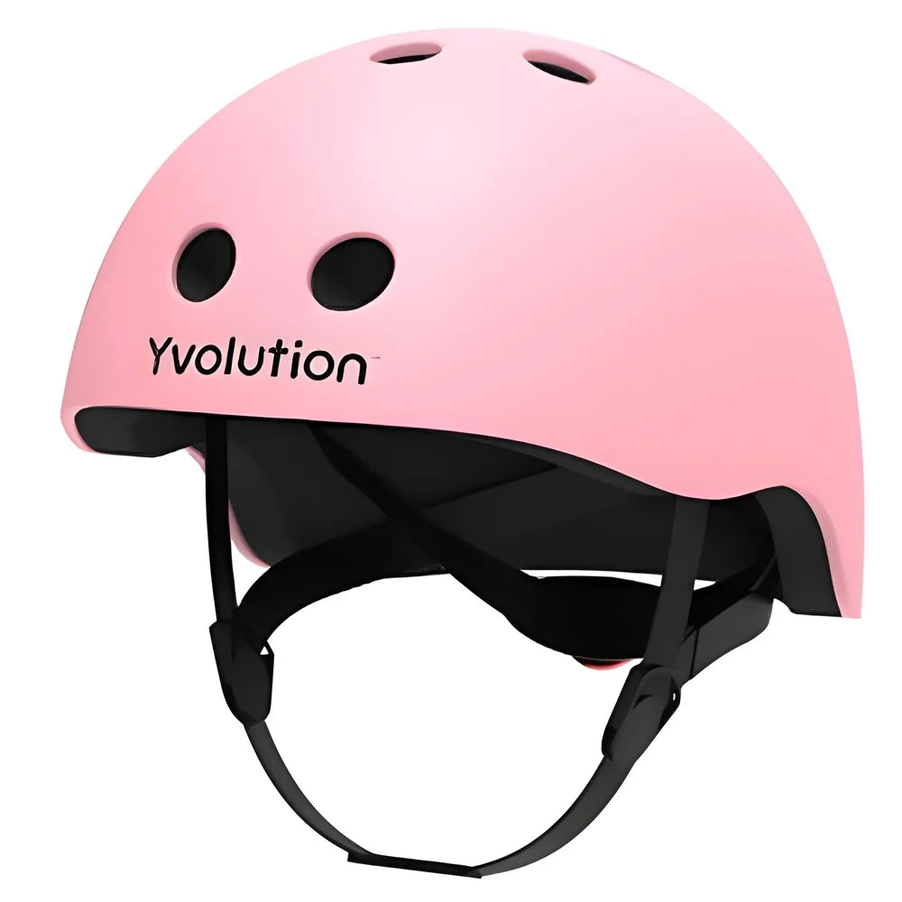 Pink Yvolution kids helmet angled view showing shell shape, vents, and strap system