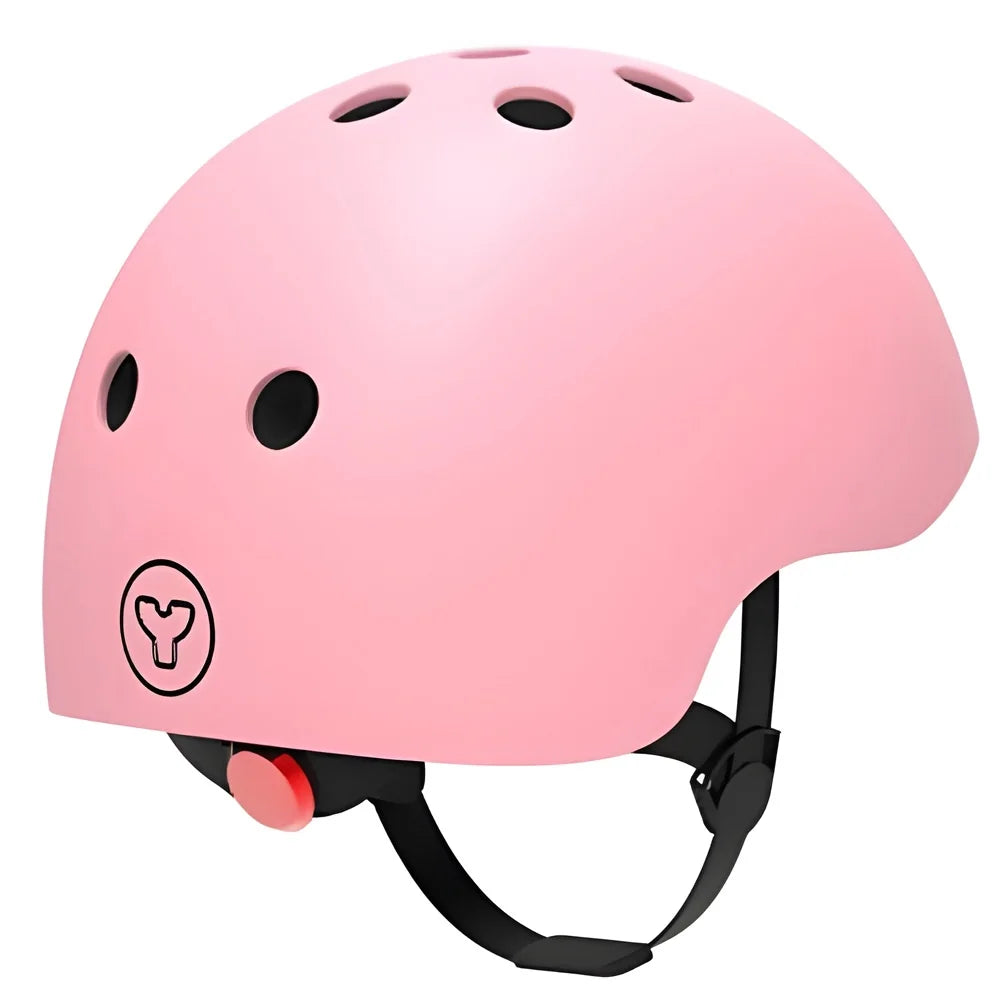 Pink Yvolution kids helmet rear view showing vents, logo, and adjustment dial on a white background