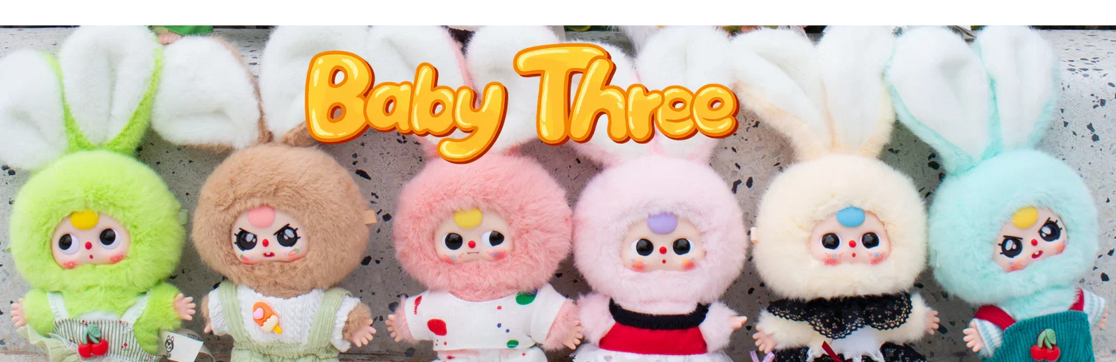 Cute Baby Three plush toys with large bunny ears in pastel colours, displayed in a row in Ireland.