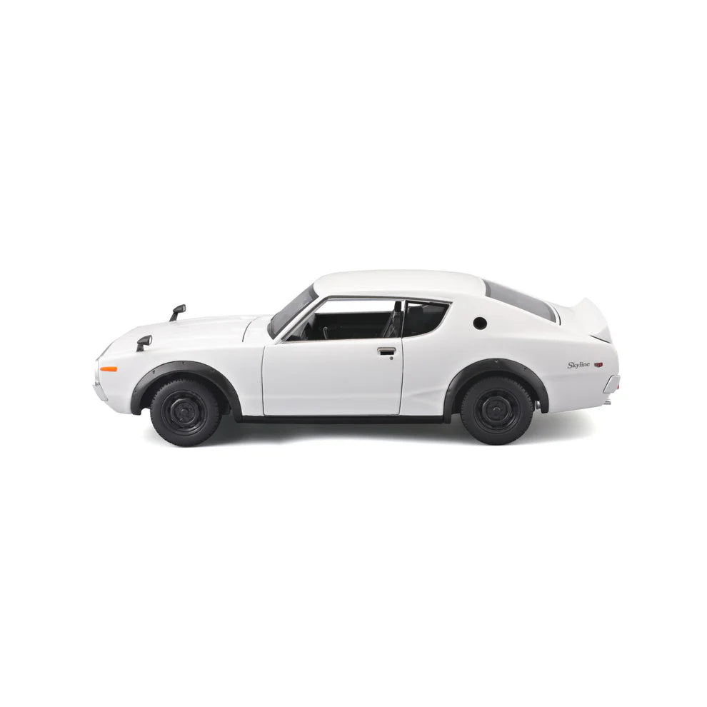 Left side view of the white 1:24 Nissan Skyline 2000GT-R model with black wheels, side mirrors, rear spoiler and Skyline GT-R side badge