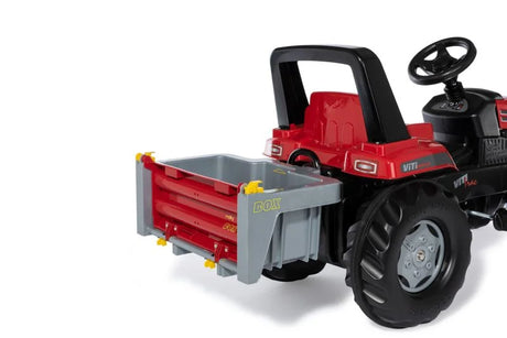 Rolly transport box attached to the rear hitch of a red pedal tractor for realistic farm play