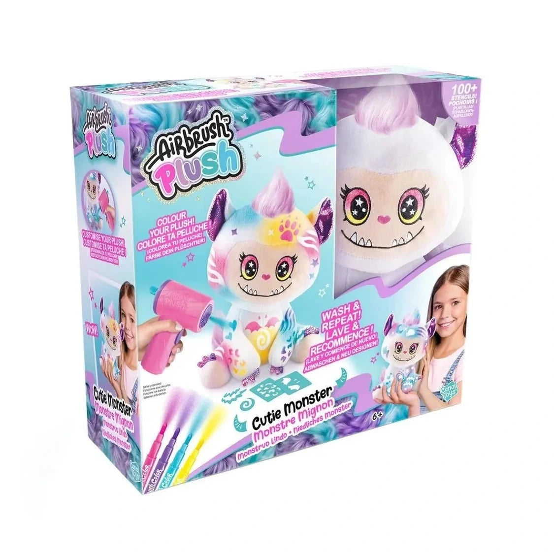 Airbrush Plush Cutie Monster retail box showing the white monster plush with pink hair, sparkly purple ears and starry eyes through the packaging window, with colourful decorating examples on the box.