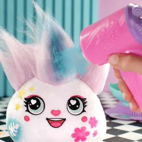 Closeup of plush character being styled with blue airbrush spray – Ireland