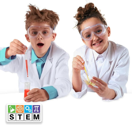 Two children wearing safety goggles and lab coats using pipettes and containers with the Amazing Kitchen Chemistry set