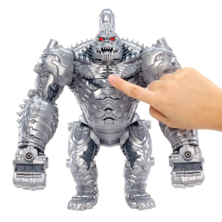 Armorsaurs King Chrome metallic silver figure with glowing red eyes, mechanical armour, bulky arms and one hand raised towards its chest against a white background.