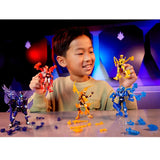 Child holding red and yellow Armorsaurs figures with more action figures and loose armour parts on a table