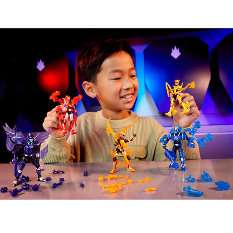 Child holding red and yellow Armorsaurs figures with purple, orange and blue figures and loose armour parts on a table