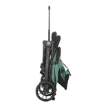 Asalvo Kubic 2 green stroller folded upright with wheels and carry handle visible
