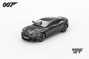 Mini GT James Bond No Time To Die Aston Martin DBS grey RHD prototype viewed from the front left showing the grille, bonnet vents, black roof and alloy wheels