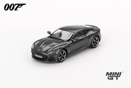 Mini GT James Bond No Time To Die Aston Martin DBS grey RHD prototype viewed from the front left showing the grille, bonnet vents, black roof and alloy wheels