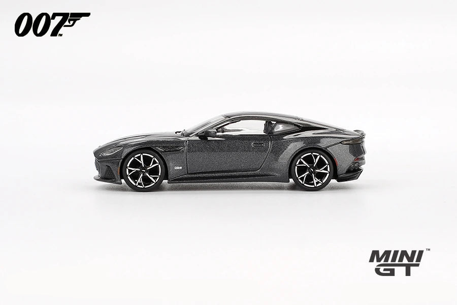 Grey Aston Martin DBS from No Time To Die in full right side profile showing the long bonnet, black roof panel, side vent and multi spoke wheels