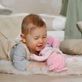 Baby playing with Baby Annabell For Babies Sweetie Pink 30cm on a soft rug