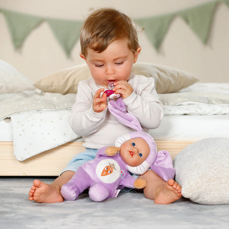 BABY born Funny Bunny on child's lap while child holds the attached dummy
