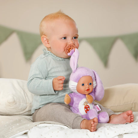 BABY born Funny Bunny beside baby with dummy attached to the bunny ear clip