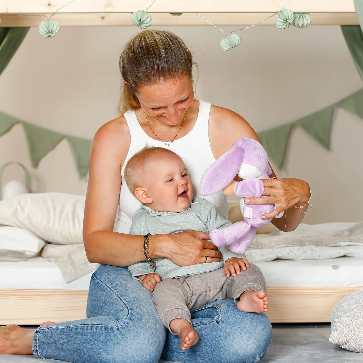 BABY born Funny Bunny used as a hand puppet beside smiling baby