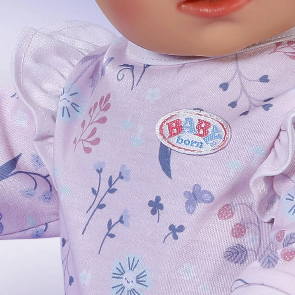 Baby Born Romper Forest 43cm close up showing Baby Born logo and forest print