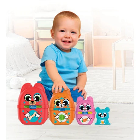 Smiling young child wearing a blue T-shirt playing with Baby Clementoni What's Inside? animal nesting toys, showing the red dog, orange cat, pink rabbit and blue mouse.
