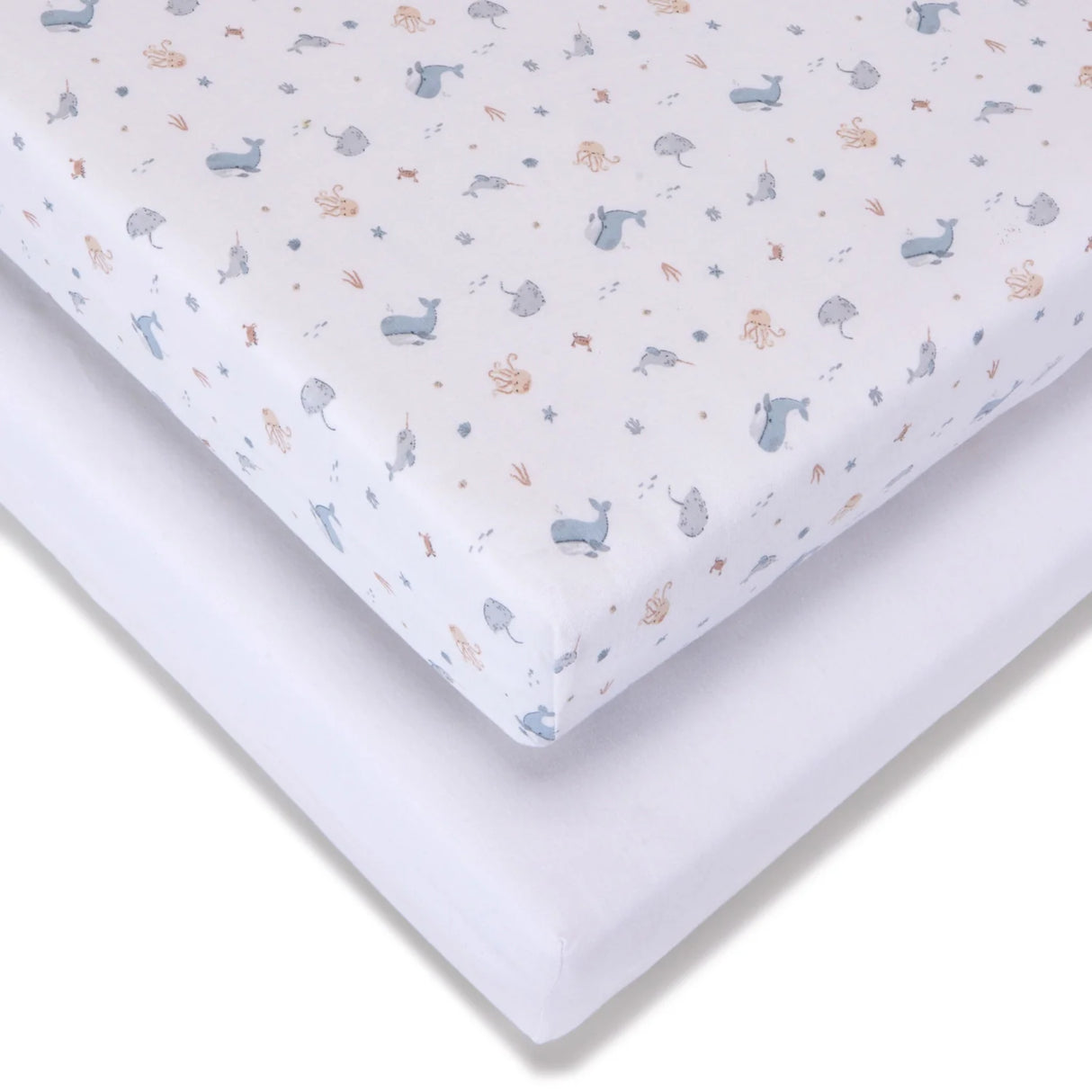 Close view of the Under the Sea patterned jersey travel cot sheet fitted over a mattress corner with a second plain white sheet visible underneath