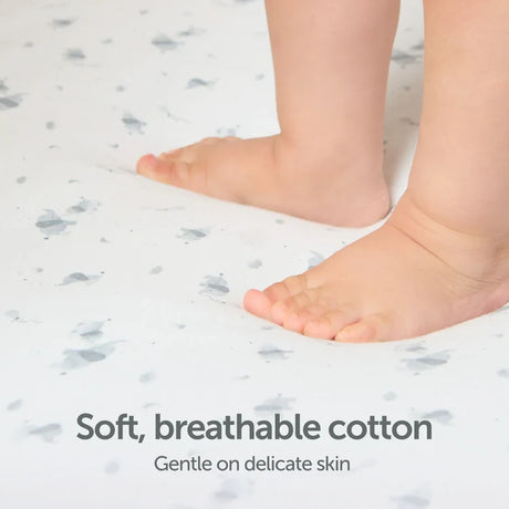 Baby feet on Baby Elegance Safari jersey fitted sheet with animal print