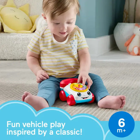 Baby turning the dial on the Fisher-Price Chatter Telephone Vehicle