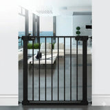 Babylo Easy Fit Flat Bar Safety Gate in black installed within a white doorway frame, showing vertical flat bars, central walk through opening and slim handle with pressure mount spindles at each side