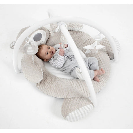 Baby lying inside Babyzee Bear Necessities Play Gym with padded bear ring, overhead arches and hanging plush toys