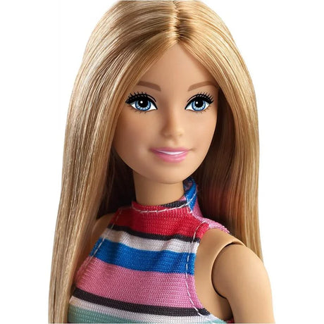 Close-up of Barbie fashion doll with blonde hair, blue eyes, and striped top