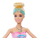 Close view of the Barbie In The Nutcracker Clara Doll with blonde hair in a bun, a blue bow headband, blue eyes and a heart necklace.