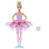 Barbie In The Nutcracker Clara Doll with her hands together over a pink patterned tutu, pale pink tights and blue ballet shoes.