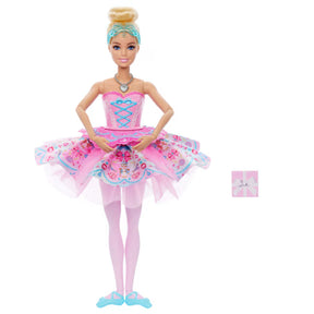 Barbie In The Nutcracker Clara Doll with her hands together over a pink patterned tutu, pale pink tights and blue ballet shoes.