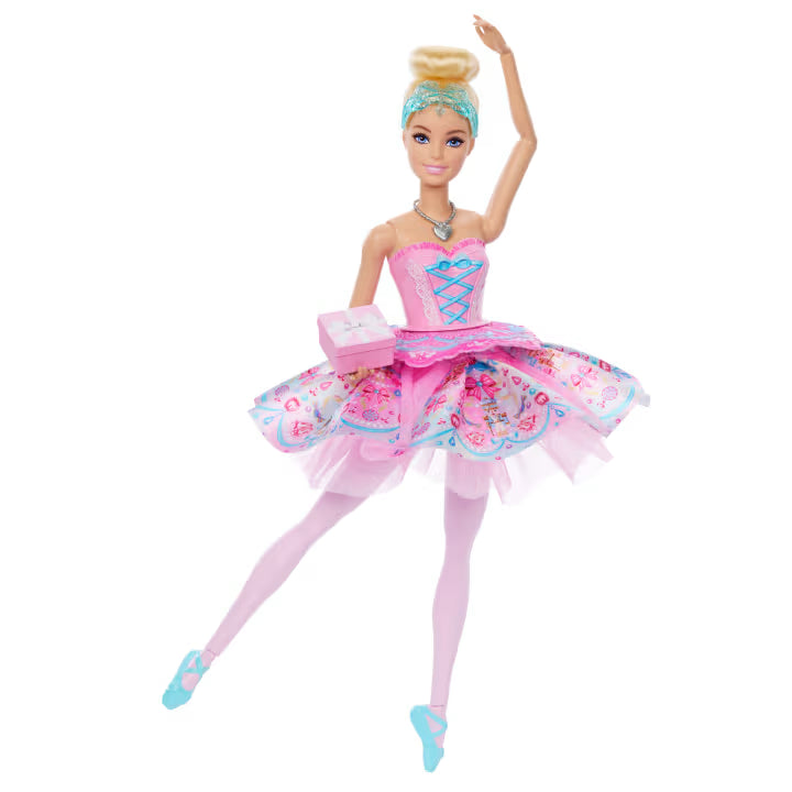 Barbie In The Nutcracker Clara Doll with one arm raised, one leg extended, a pink patterned tutu and a small pink gift box.