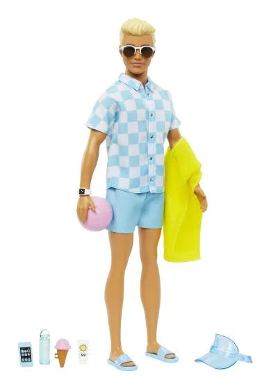 Ken doll posed for play, blue check shirt and sky blue swim shorts, towel and summer accessories arranged at his feet