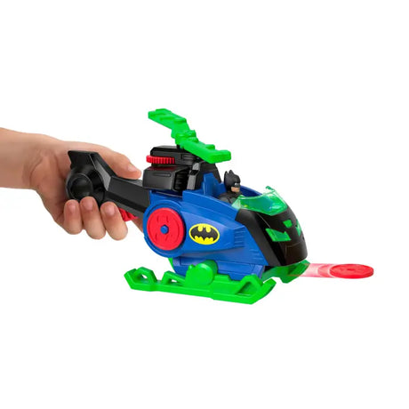 Hand holding the Batcopter as a red disc launches from the front