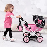 Child pushing Bayer Design Dolls Pram Cosy pink doll pram with black polka dot hood