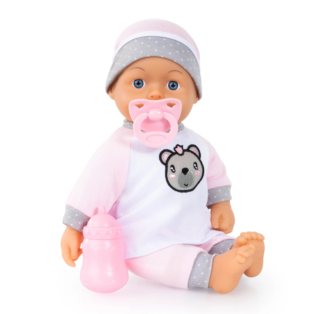 Bayer Kiss Baby Doll sitting with pink bottle in hand and pacifier in mouth on white background