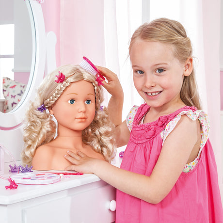 Child brushing Bayer Super Model doll styling head with pink brush at a dressing table